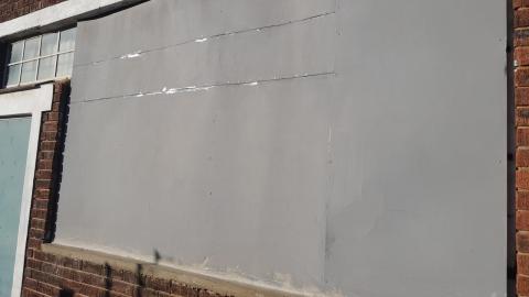 The ugly wall before the mural is painted